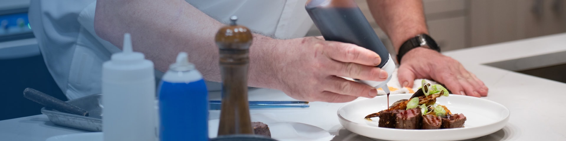 A chef preparing a plated meal in the Recovery Keys kitchen as part of nutrition therapy